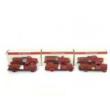 Three vintage metal fire truck models with boxes