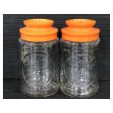 Two vintage glass Tang jars with plastic lids