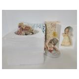 Trio of porcelain and resin figurines