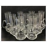 Set of nine low handled glass beer mugs