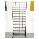 Standing black metal grid wall display