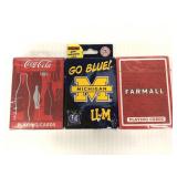 Three unopened packs of playing cards