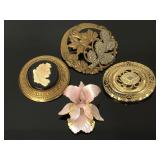 Four gold toned brooches