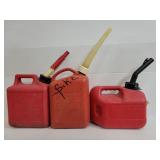 Three assorted plastic gas cans with spouts