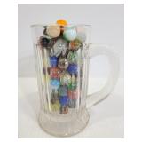 Collection of vintage marbles in glass mug