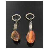 Pair of signed amber stone keychains
