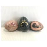 Three colored marble stone eggs