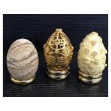 Trio of carved, stone, & metal eggs