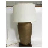 Bronze colored table lamp on wooden base