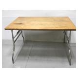 Wooden table with folding legs