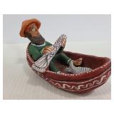 Clay fisherman in boat figure