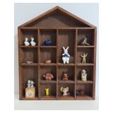 Wood house shaped shelf with tiny treasures