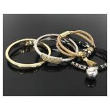 Four silver & gold tone bracelets