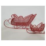 Two vintage red metal sleighs