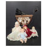 Vintage small baby pram with mini porcelain dolls