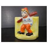 Ceramic boy ice-skating planter