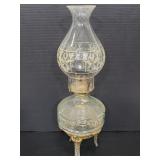 Antique glass oil lamp on metal pedestal