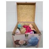 Pink floral box of vintage dolls