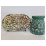 Metal trivet and pottery vase