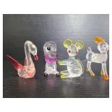 Four plastic artsy animal figures