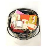 Floral tin container of assorted sewing material