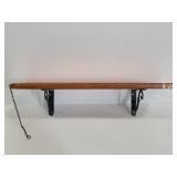 Wood wall shelf on metal brackets