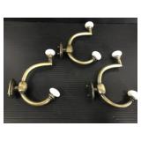 Trio of metal & porcelain wall hooks