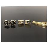 Gold toned cuff links and one matching tie clip