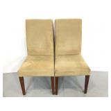 Two matching tan microfiber dining chairs