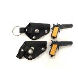 Two miniature toy guns in holster keychains