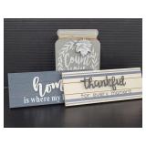 Three assorted home decor signs
