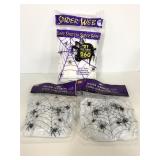 Three unopened Halloween spider web decor