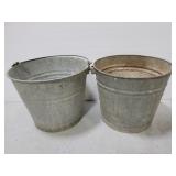 Two assorted decorative garden metal pales