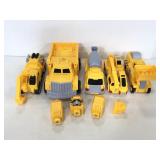 Five assorted Transformers construction trucks