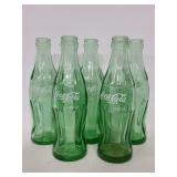 Five vintage Coca-Cola glass bottles