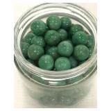 Jar of green swirl marbles