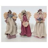 Three faceless signed angels