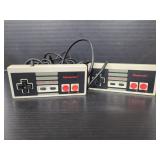 Two vintage Nintendo NES-004 controllers