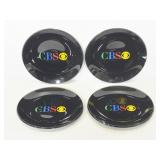 Four black CBS saucers