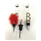 Two wine stoppers and a pourer