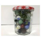 Jelly jar of vintage marbles