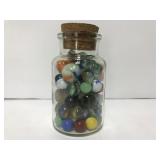 Corked jar of vintage marbles