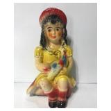 Old vintage chalkware girl with peacock Bird