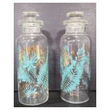 Two decorative glass bottles with tops
