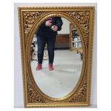 Gold tone ornate framed mirror