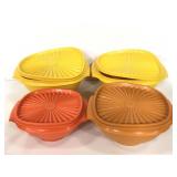 Four assorted vintage Tupperware bowls with lids
