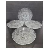 Set of four clear glass flower bowls