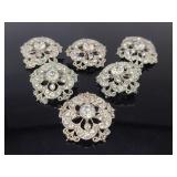 Six ornate jeweled charms