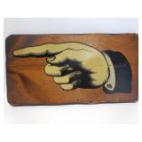 Pointing finger on wood sign