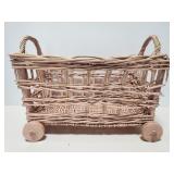 Pink wicker basket with wood wheels